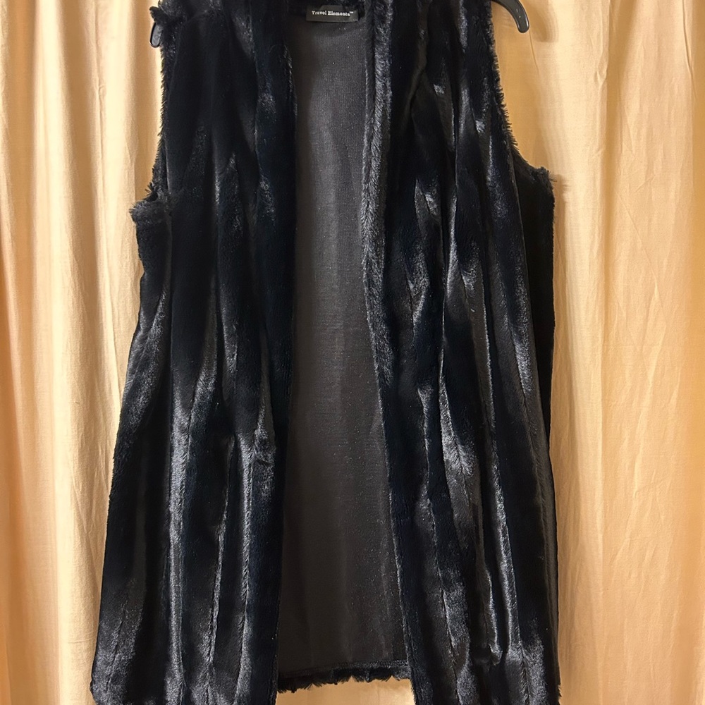 Faux fur. Super soft. Gorgeous vest.  Soft- worn once.